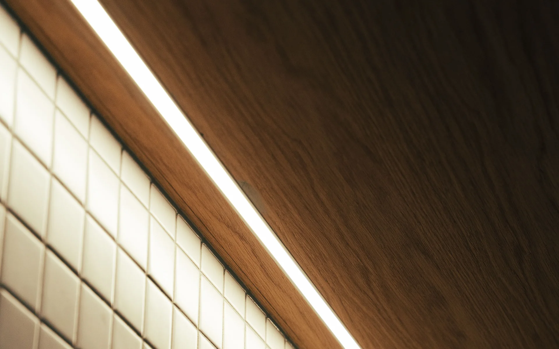 Linear LED light running along a timber-lined ceiling