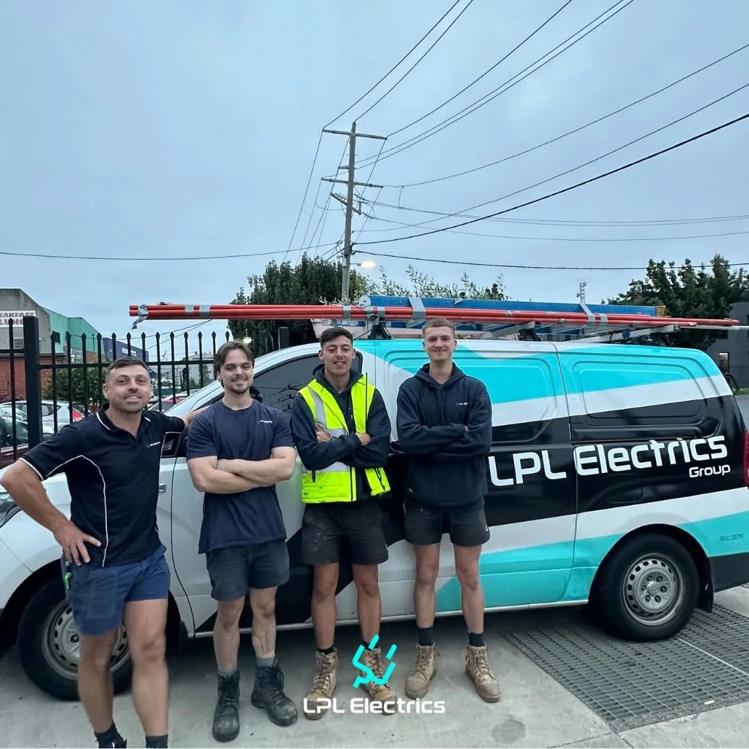 LPL Electrics Group electricians standing beside a branded work van