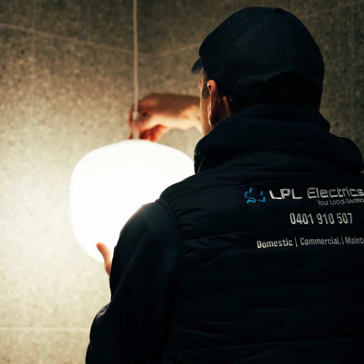 LPL Electrics electrician fitting a globe pendant light